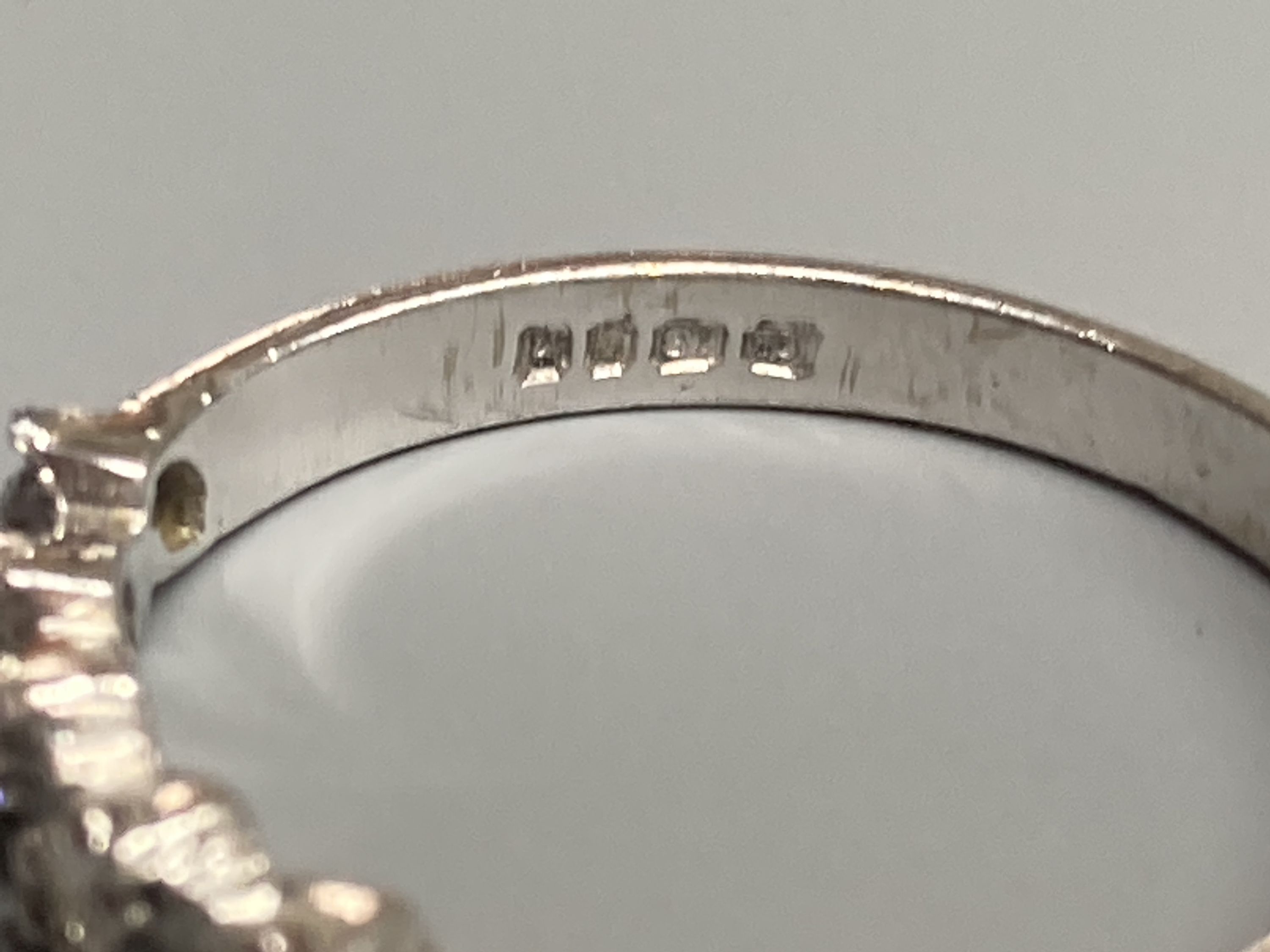 A modern 18ct white gold and nine stone diamond set half eternity ring, size N, gross 3 grams.